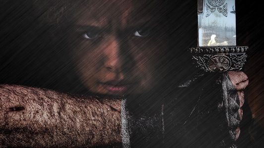 The Arcadian promo image; Young girl and a warrior's arm holding a sword